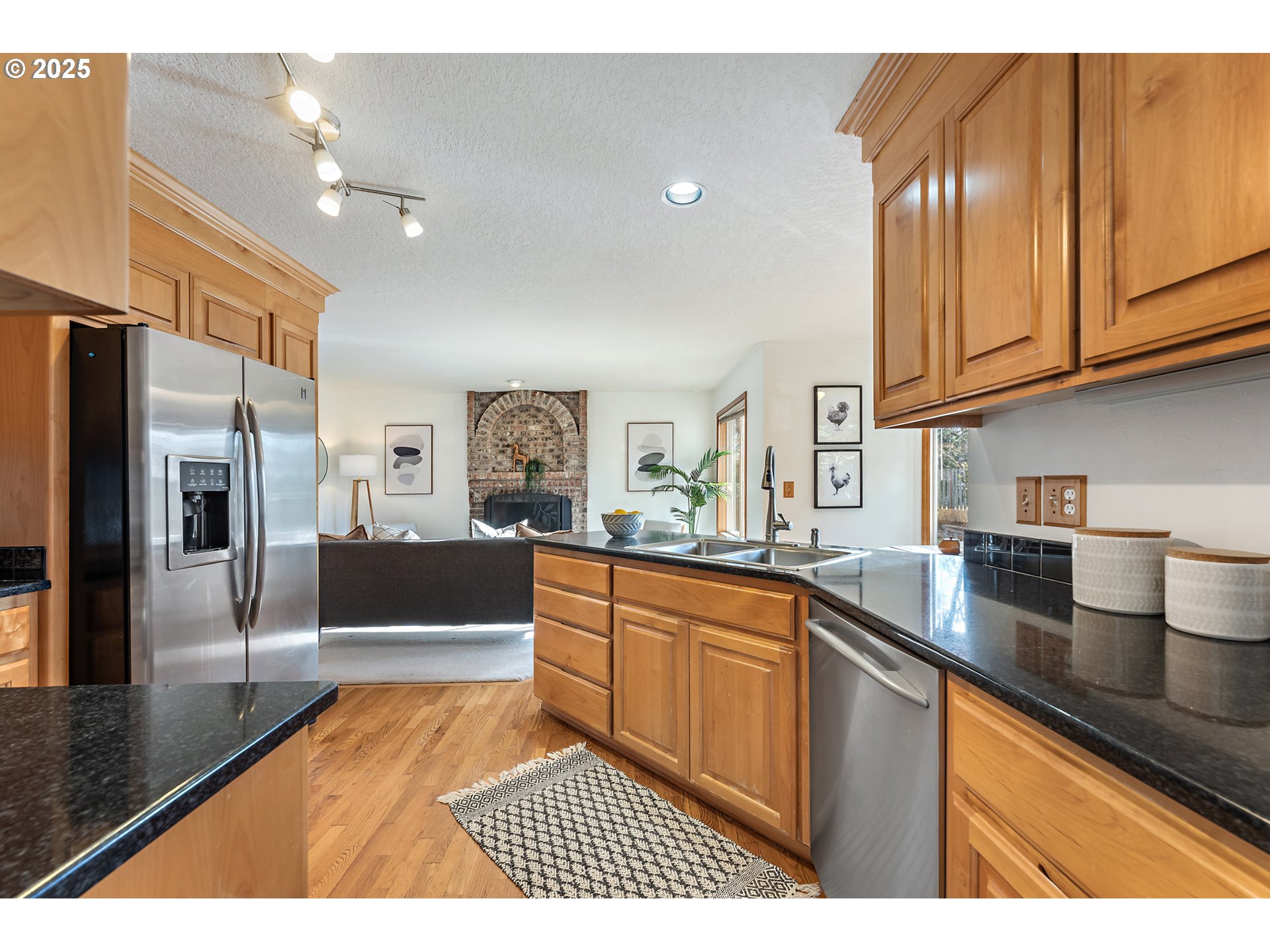 20259 Southwest Celebrity Street Beaverton, OR 97078 - Photo 12 of 40 a kitchen with stainless steel appliances granite countertop a sink and cabinets