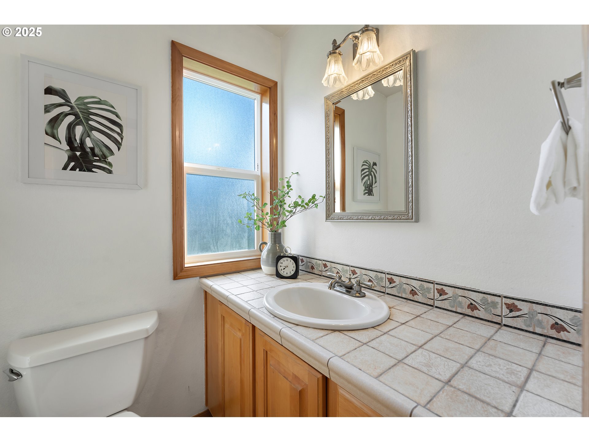 20259 Southwest Celebrity Street Beaverton, OR 97078 - Photo 16 of 40 a bathroom with a sink a mirror and a toilet
