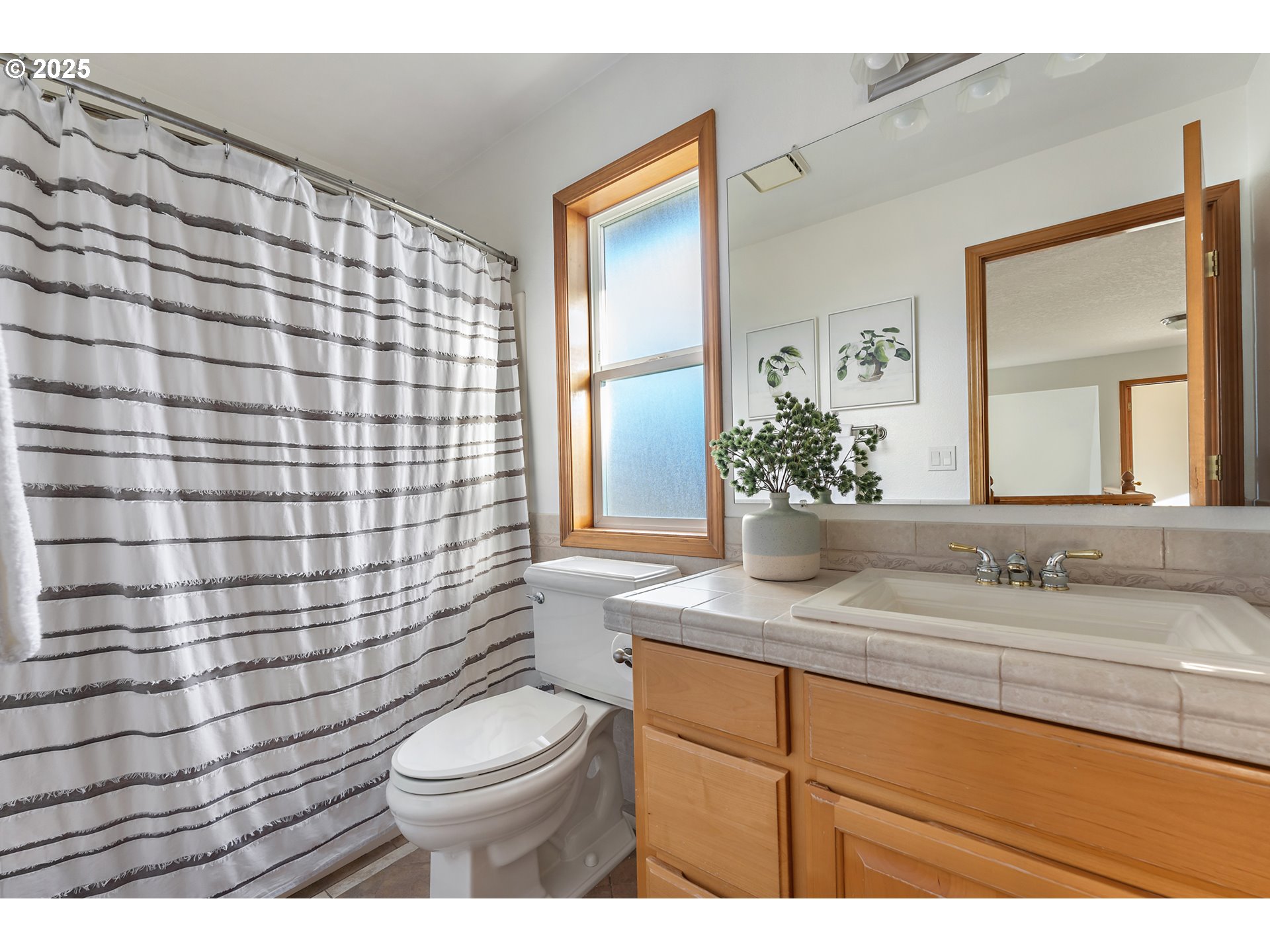 20259 Southwest Celebrity Street Beaverton, OR 97078 - Photo 25 of 40 a bathroom with a granite countertop toilet sink mirror and shower