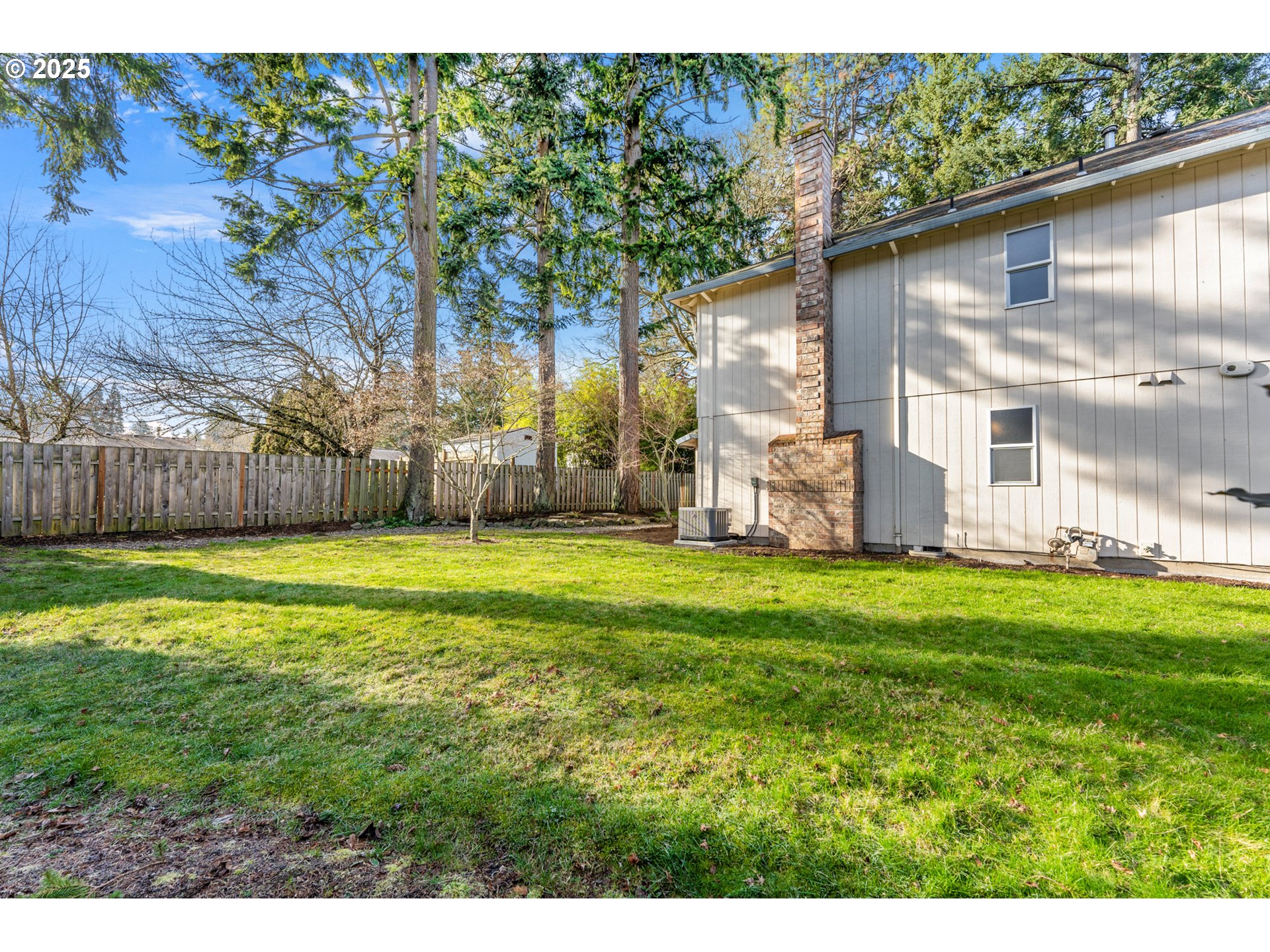 20259 Southwest Celebrity Street Beaverton, OR 97078 - Photo 27 of 40 a backyard of a house with lots of green space