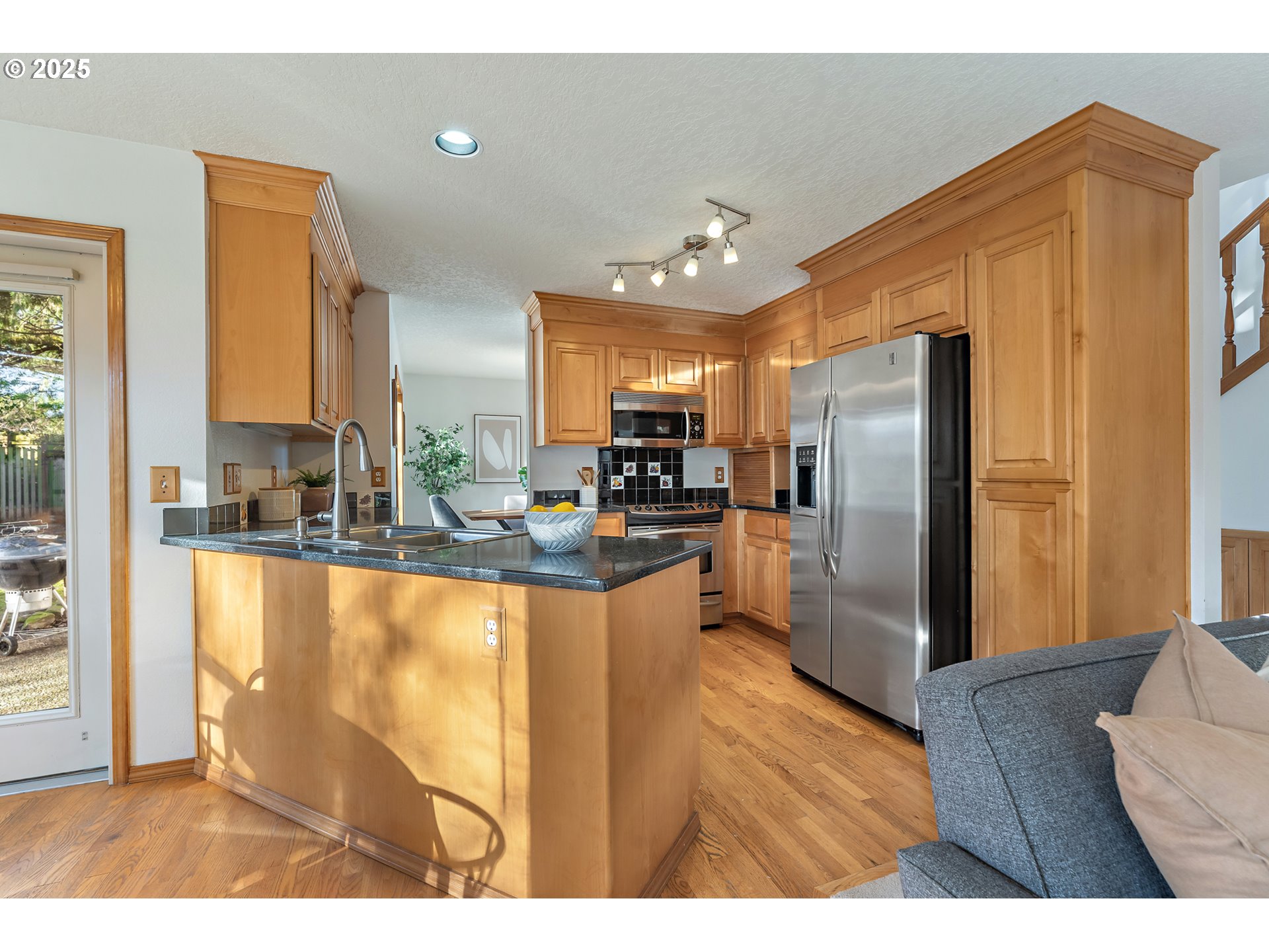 20259 Southwest Celebrity Street Beaverton, OR 97078 - Photo 9 of 40 a kitchen with stainless steel appliances granite countertop a refrigerator a sink and a stove
