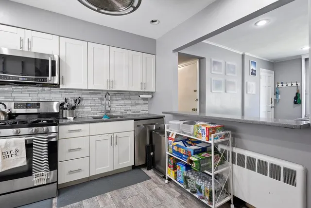 a kitchen with stainless steel appliances granite countertop a stove and a sink