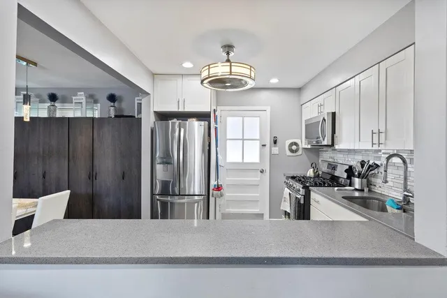 a kitchen with stainless steel appliances a refrigerator and a sink
