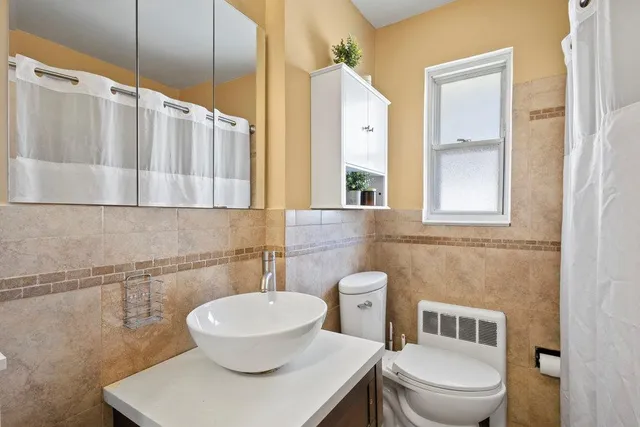 a white toilet sitting next to a bathroom sink