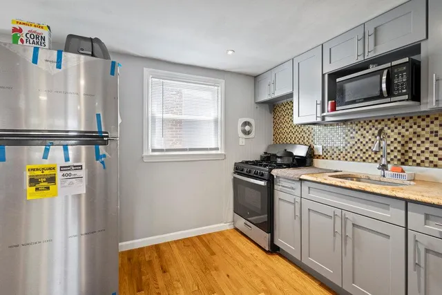 a kitchen with stainless steel appliances granite countertop a refrigerator and a sink
