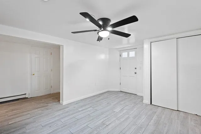 a view of an empty room with wooden floor