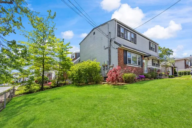 a front view of house with yard and green space