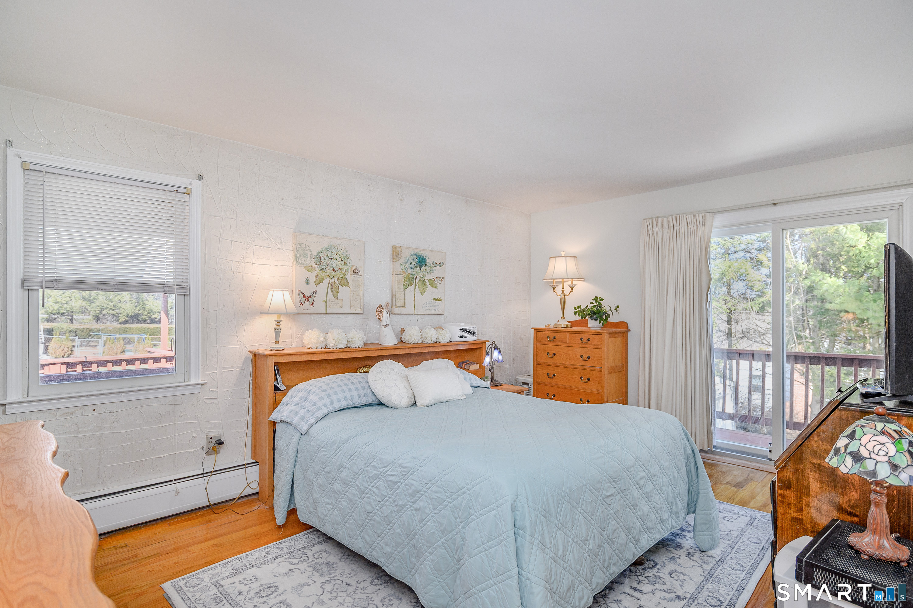 27 Jotham Road New Milford, CT 06776 - Photo 11 of 37 a bedroom with a bed and wooden floor