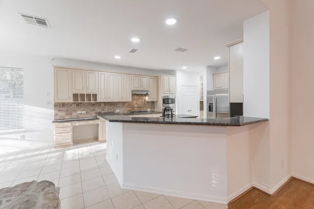 a kitchen with stainless steel appliances granite countertop a sink and cabinets