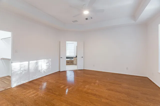 a view of empty room with wooden floor