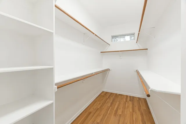 a view of closet with wooden floor