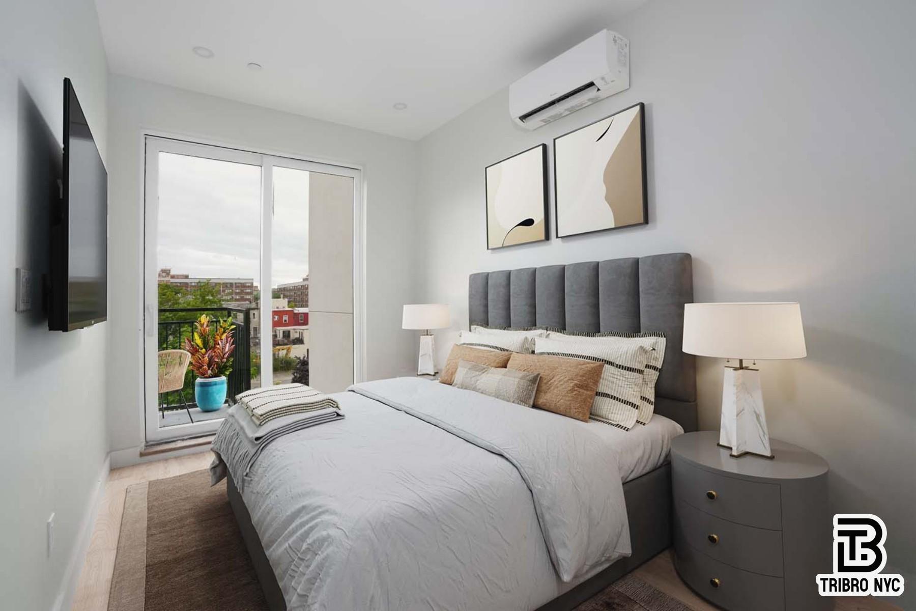 92 Manhattan Avenue, Unit 4B Brooklyn, NY 11206 - Photo 8 of 13 a bedroom with a bed a mirror and a flat tv screen on the dresser