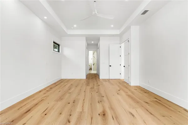 a view of empty room with wooden floor