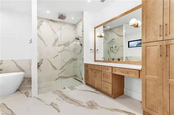 a spacious bathroom with a double vanity sink a mirror and a shower