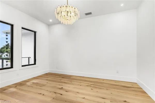 a view of a room with wooden floor and window