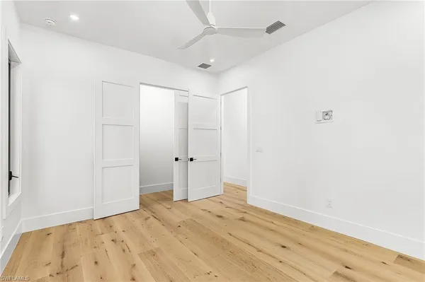 a view of a room with wooden floor