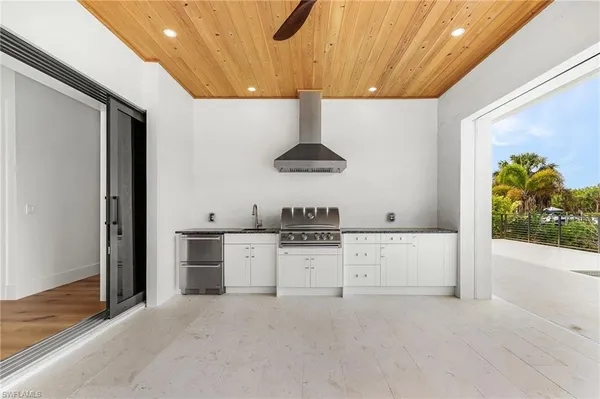 a kitchen with stainless steel appliances a stove refrigerator and a sink