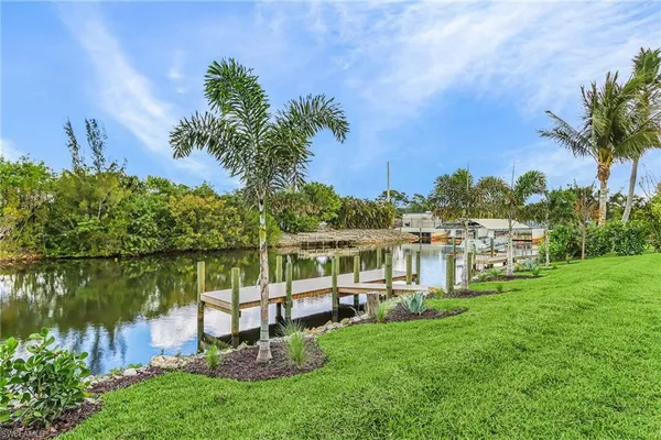 a view of a lake with a house in the background