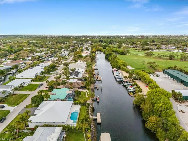 an aerial view of residential building and lake