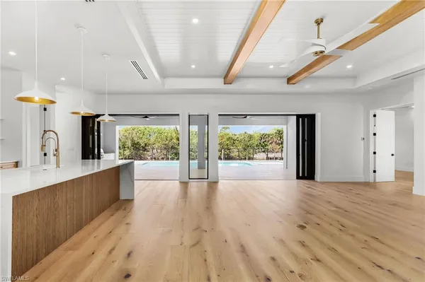 a large kitchen with a window and a sink