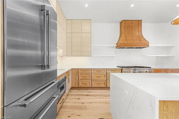 a kitchen with a refrigerator and a sink