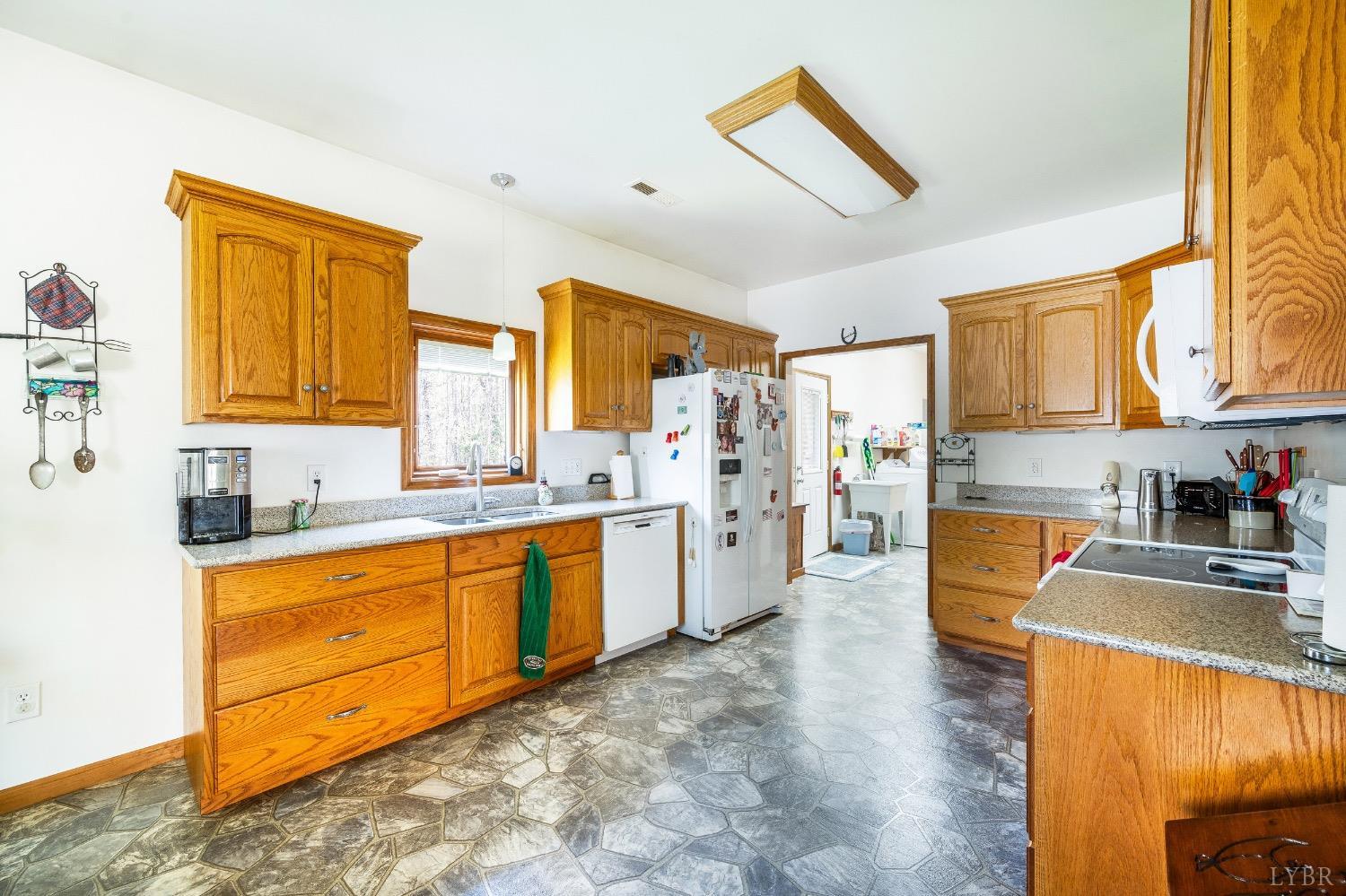 239 Little Farm Road Amherst, VA 24521 - Photo 13 of 59 a kitchen with stainless steel appliances granite countertop a sink cabinets and a refrigerator