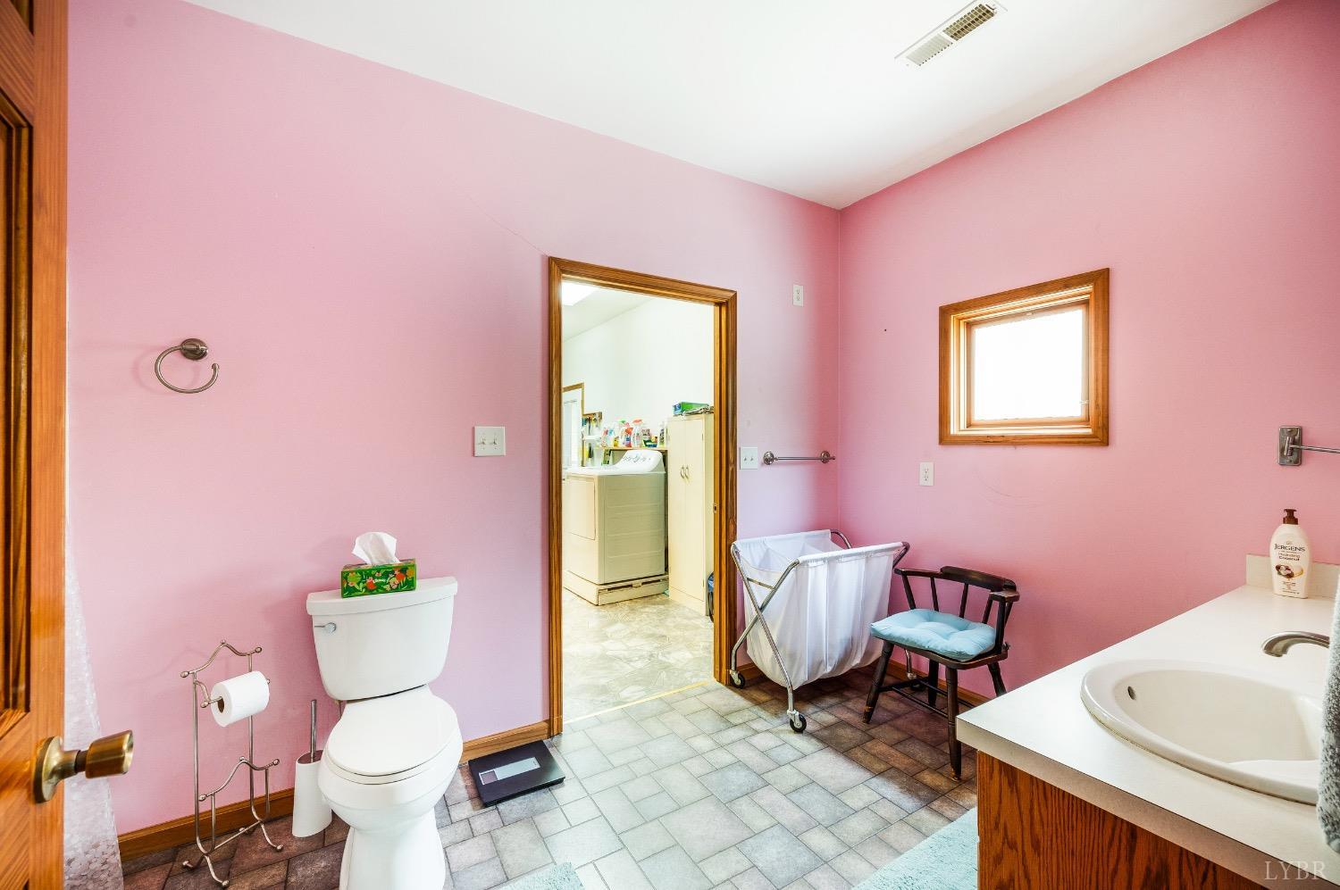 239 Little Farm Road Amherst, VA 24521 - Photo 29 of 59 a bathroom with a sink mirror vanity and a toilet