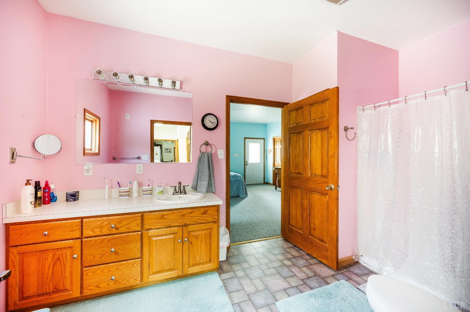 239 Little Farm Road Amherst, VA 24521 - Photo 30 of 59 a spacious bathroom with a mirror sink and shower
