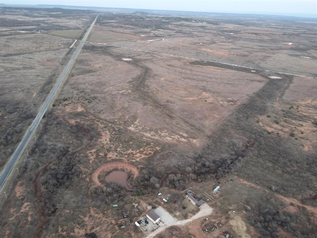 302 County Road 620 Ovalo, TX 79541 - Photo 2 of 9 a view of a dry yard with wooden floor