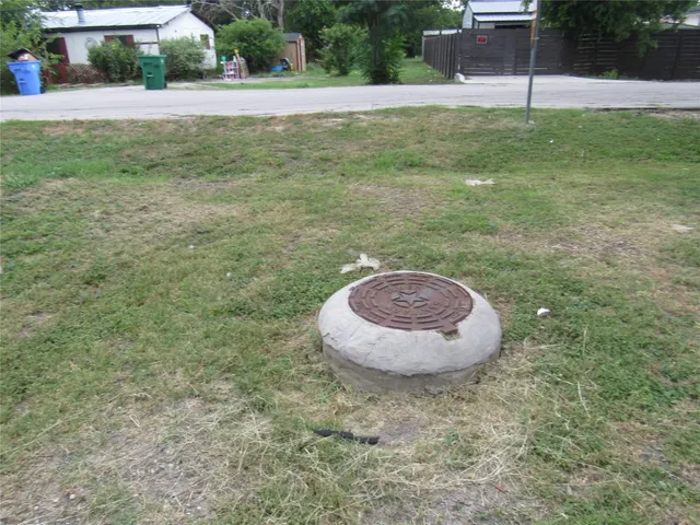 a view of a house with a big yard and a large trees