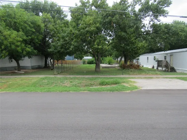a backyard of a house with trees and plants