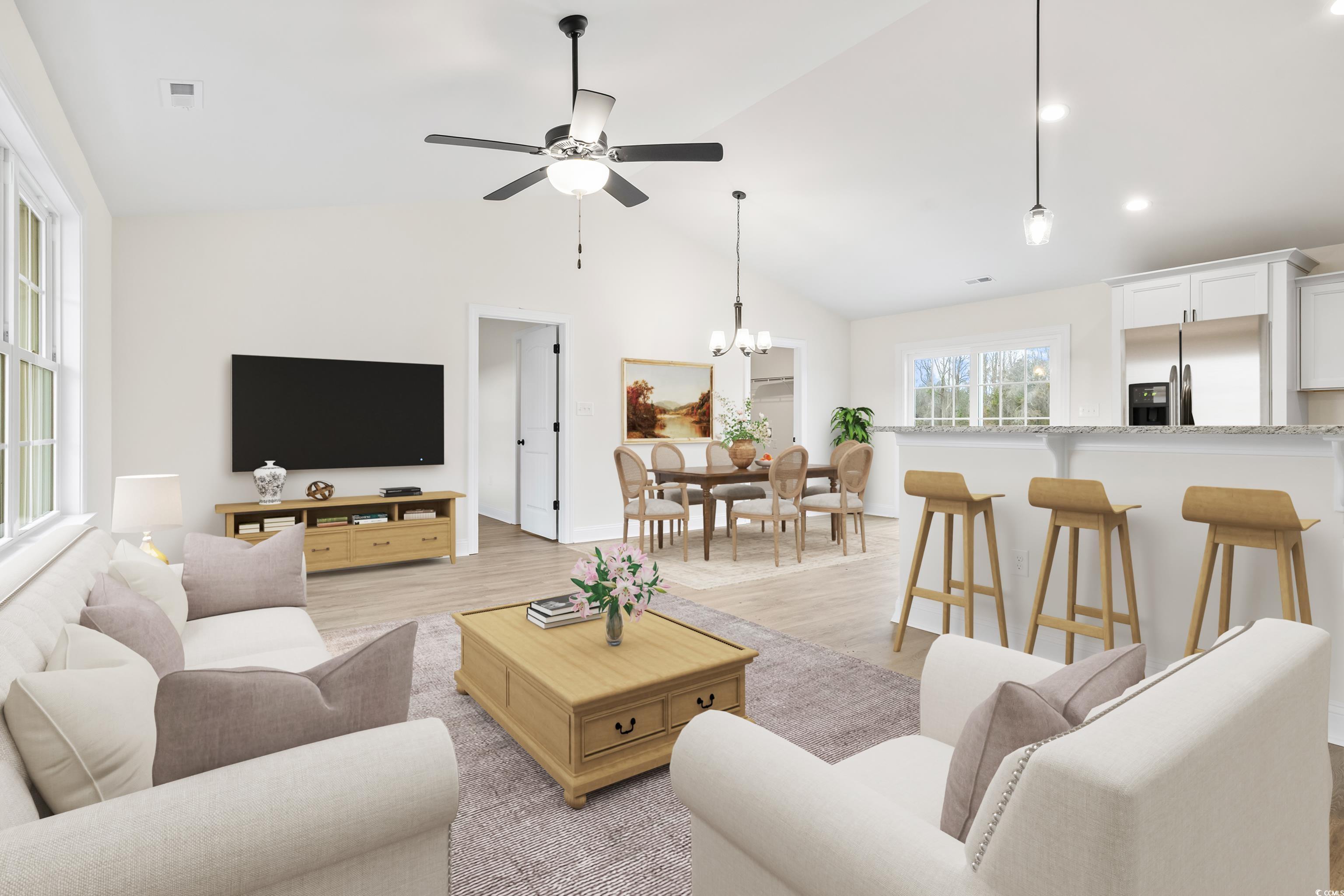 3640 Bethel Chapel Road Loris, SC 29569 - Photo 12 of 35 Living room featuring light wood-style floors, a chandelier, ceiling fan, and high vaulted ceiling