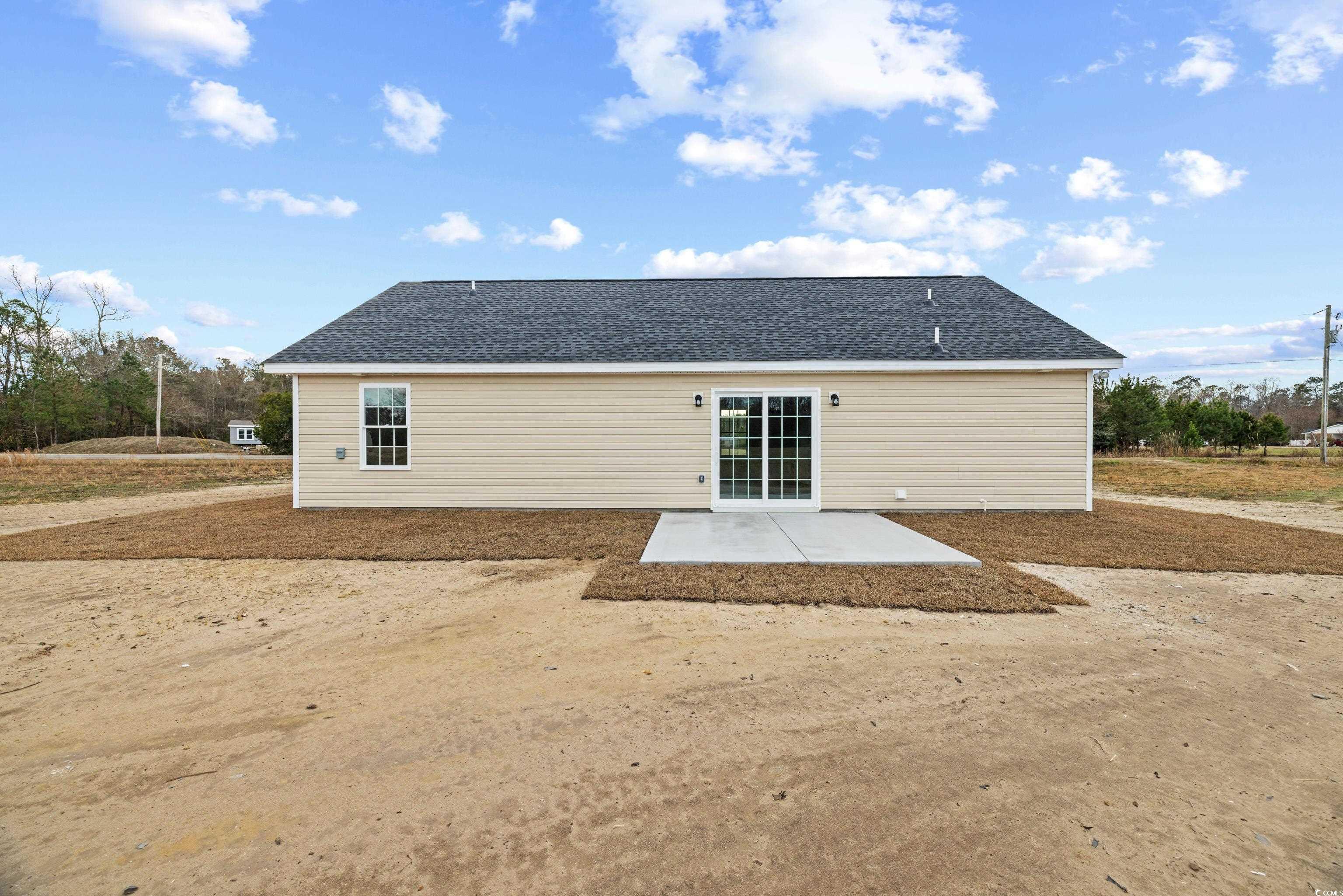 3640 Bethel Chapel Road Loris, SC 29569 - Photo 14 of 35 Rear view of house with a patio area and a shingled roof