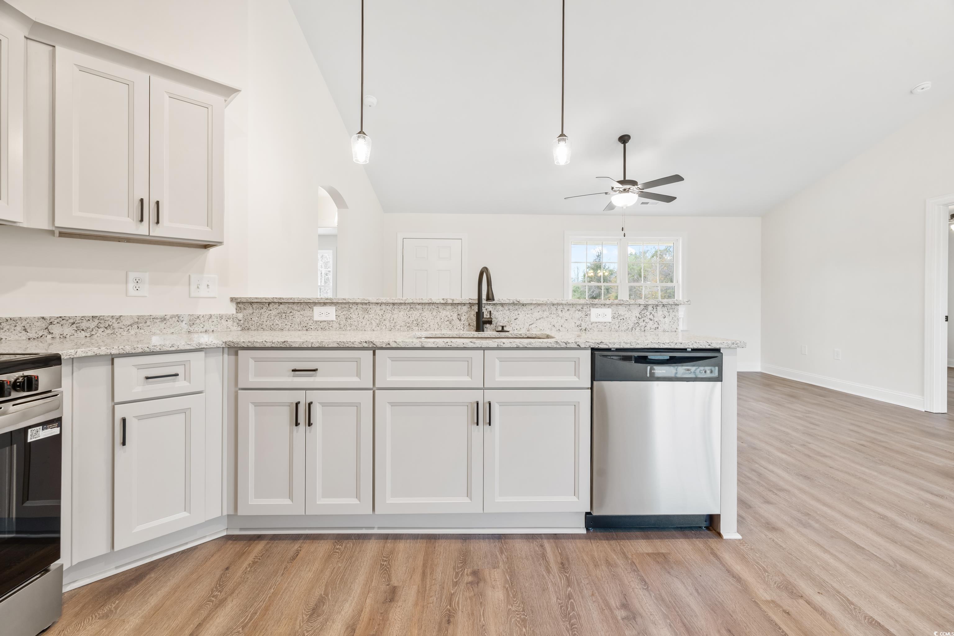 3640 Bethel Chapel Road Loris, SC 29569 - Photo 22 of 35 Kitchen featuring arched walkways, stainless steel appliances, white cabinets, light stone counters, and a ceiling fan