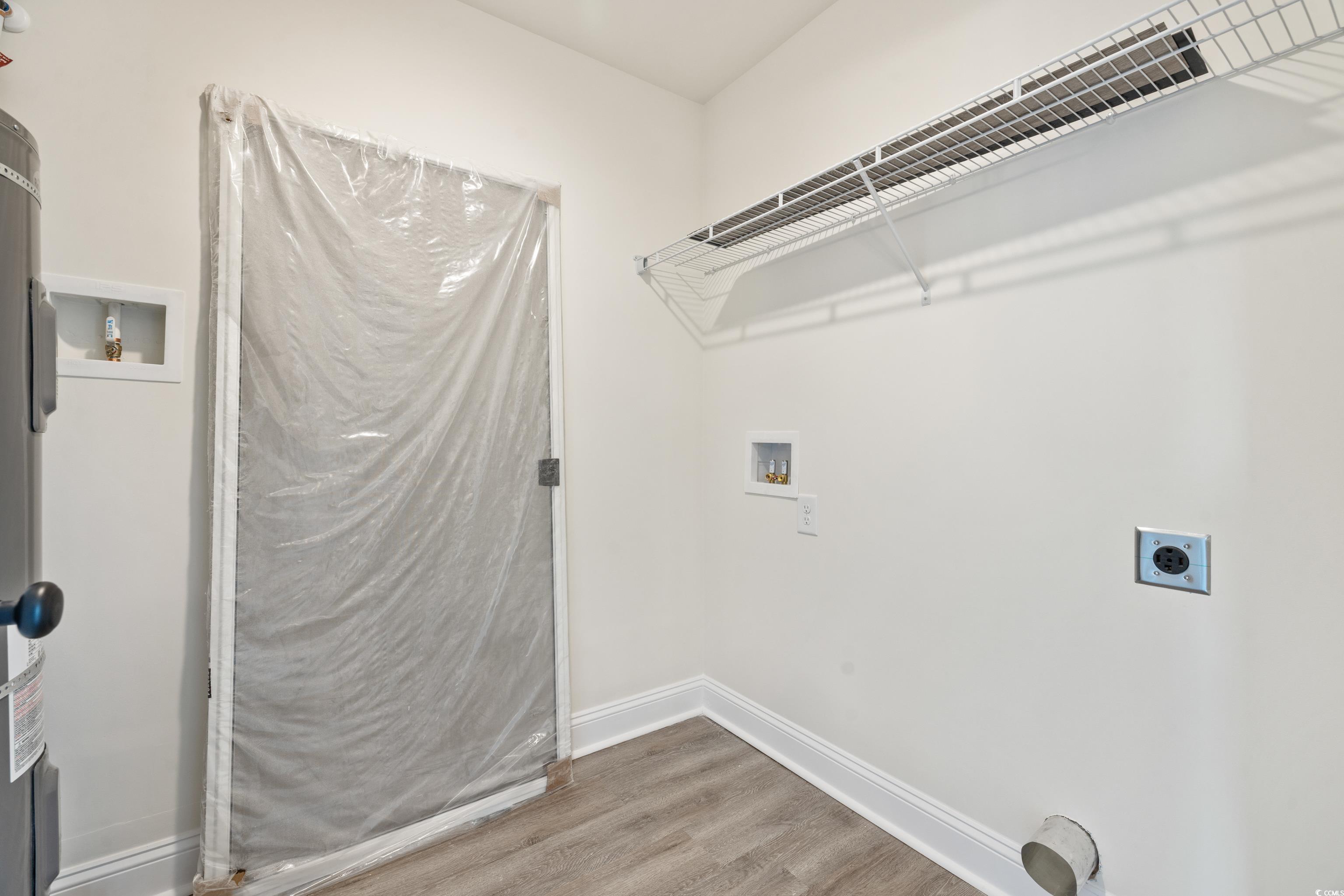 3640 Bethel Chapel Road Loris, SC 29569 - Photo 28 of 35 Washroom featuring hookup for a washing machine, hookup for an electric dryer, light wood finished floors, and electric water heater