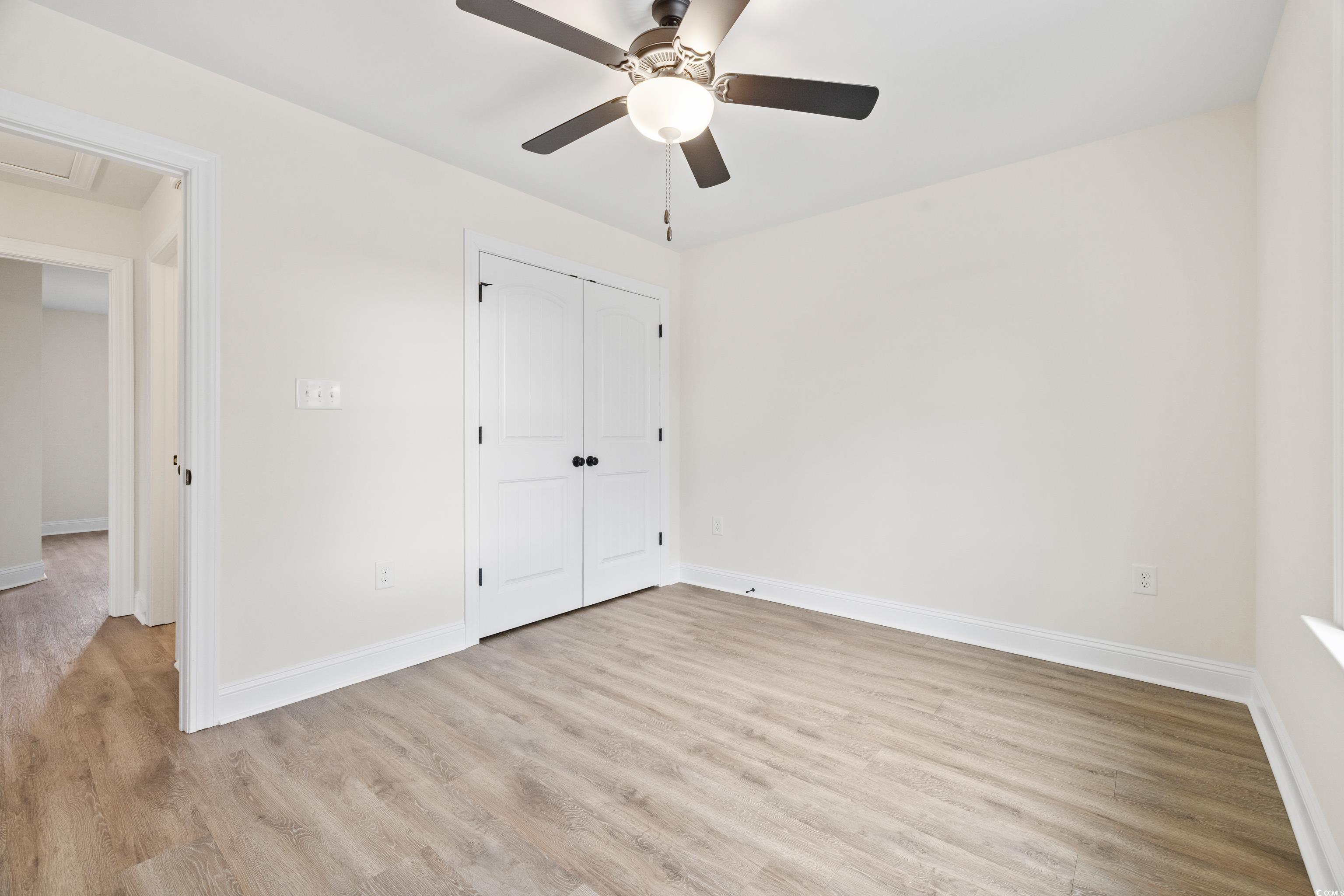 3640 Bethel Chapel Road Loris, SC 29569 - Photo 31 of 35 Unfurnished bedroom with light wood-style floors, ceiling fan, and a closet