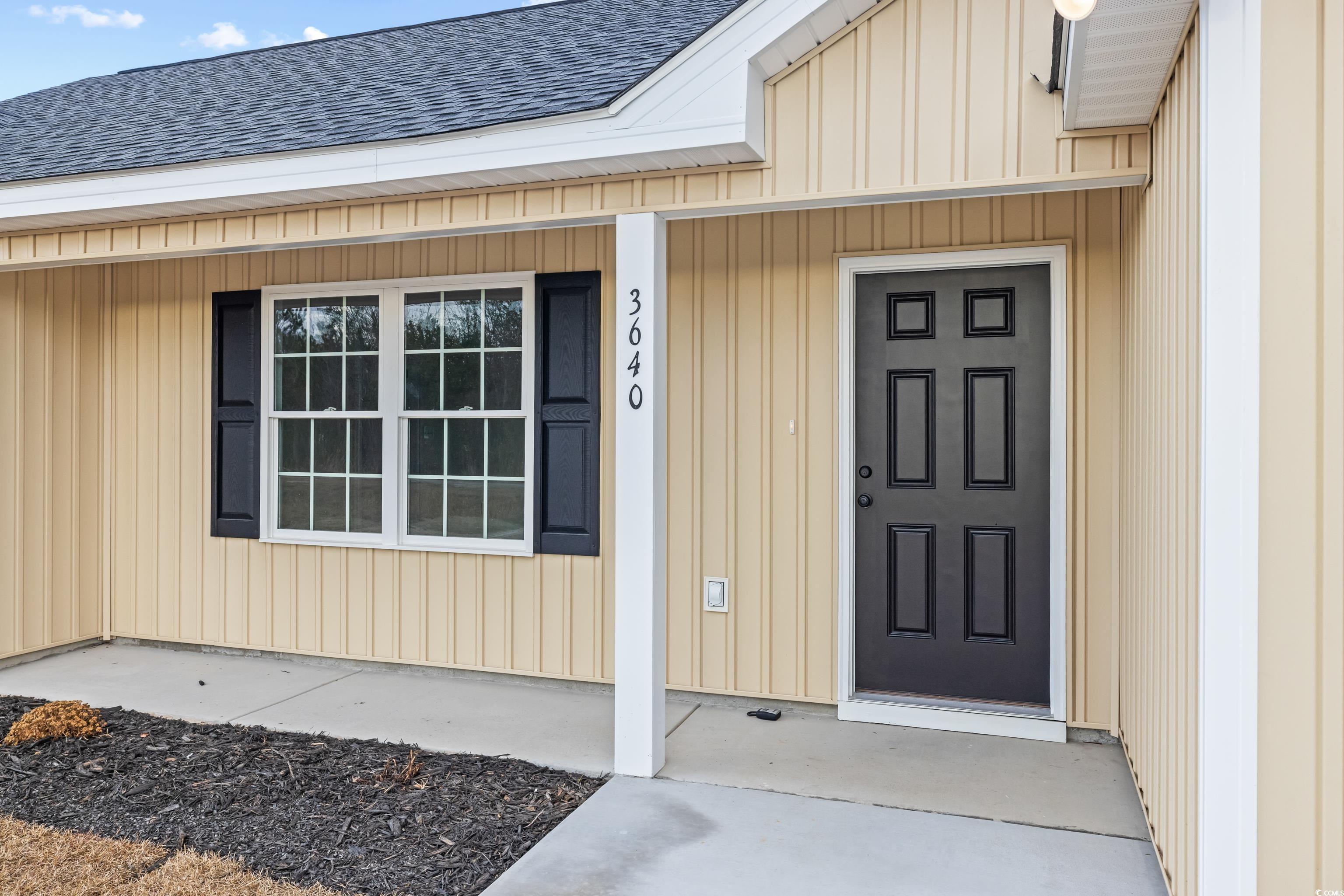 3640 Bethel Chapel Road Loris, SC 29569 - Photo 4 of 35 Entrance to property with roof with shingles, a porch, and board and batten siding