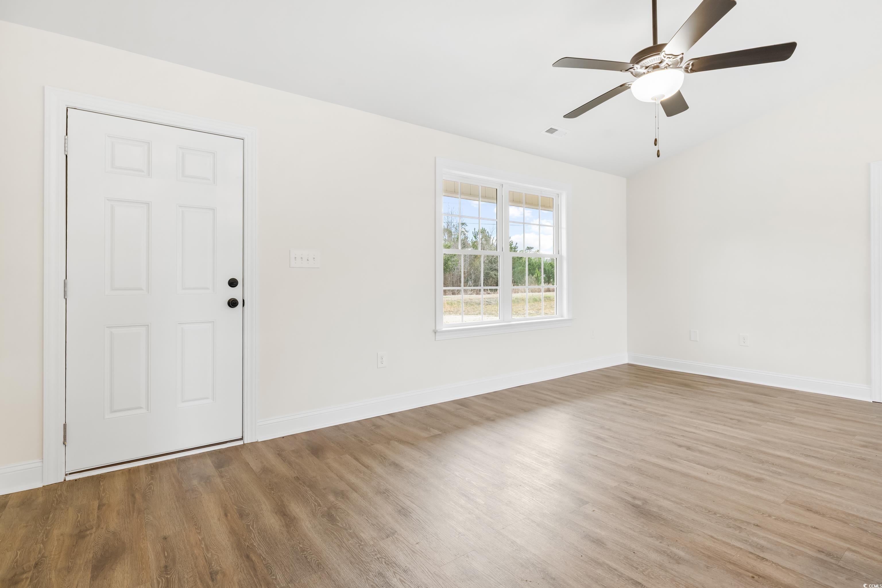 3640 Bethel Chapel Road Loris, SC 29569 - Photo 6 of 35 Spare room with wood finished floors, ceiling fan, and vaulted ceiling