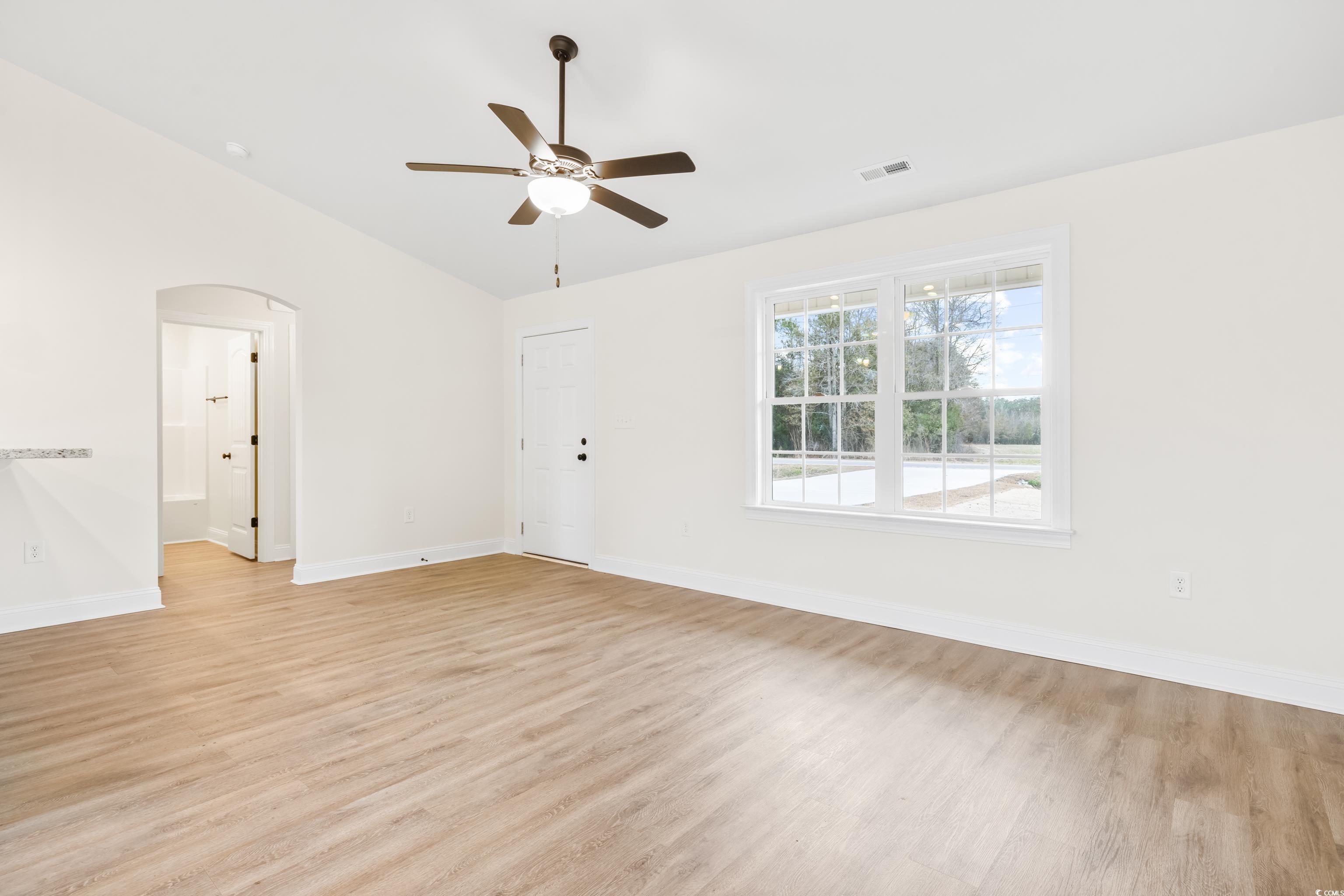 3640 Bethel Chapel Road Loris, SC 29569 - Photo 8 of 35 Unfurnished room with light wood-type flooring, ceiling fan, lofted ceiling, and arched walkways