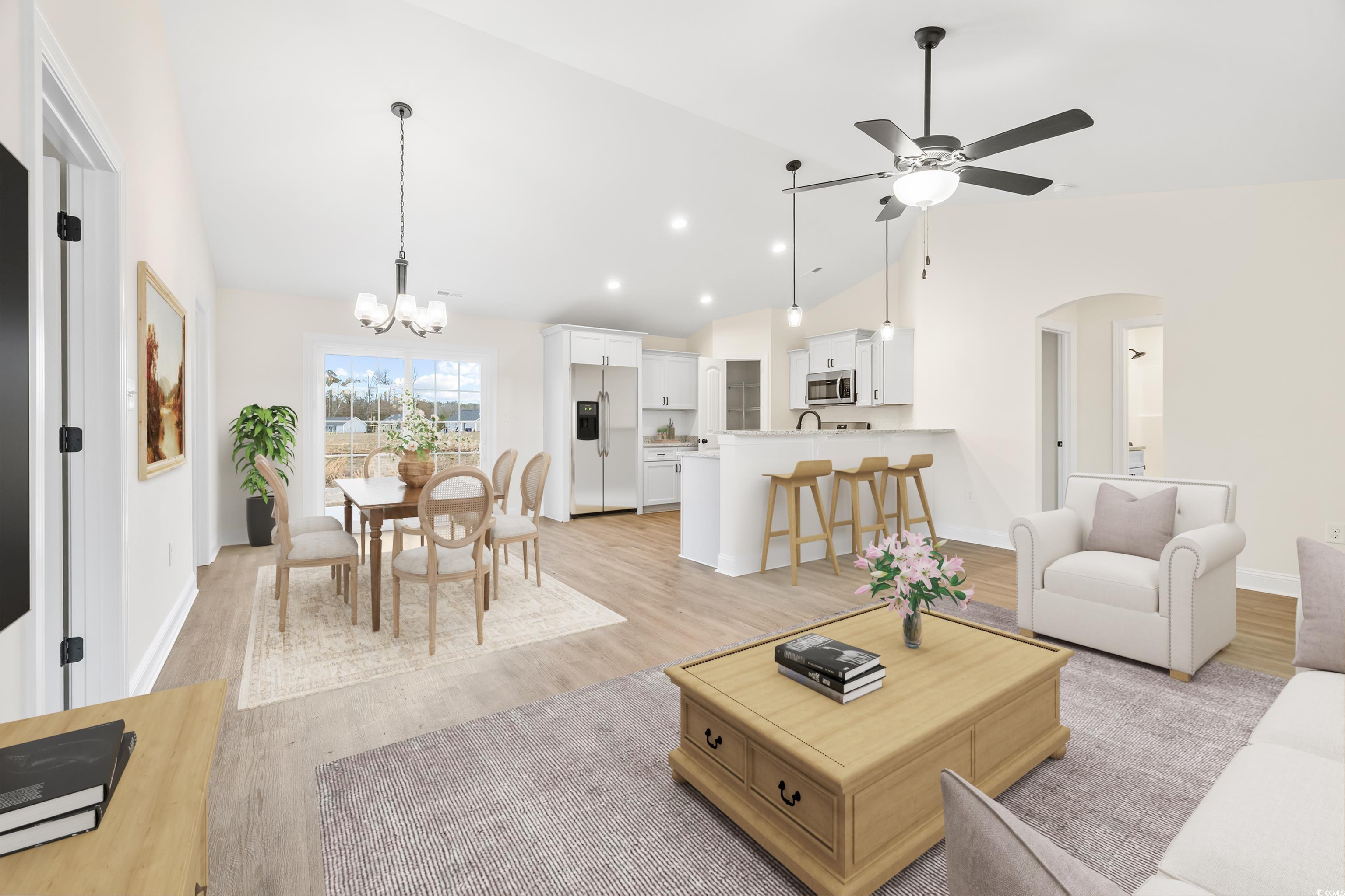 3640 Bethel Chapel Road Loris, SC 29569 - Photo 10 of 35 Living room featuring arched walkways, light wood-style floors, a chandelier, a ceiling fan, and high vaulted ceiling