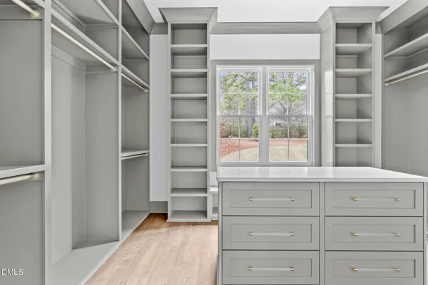 a spacious bathroom with a sink and a mirror
