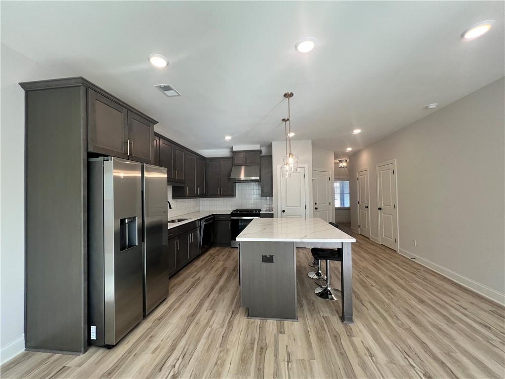 1337 Parc Bench Road Atlanta, GA 30316 - Photo 15 of 35 a large kitchen with a table and stainless steel appliances