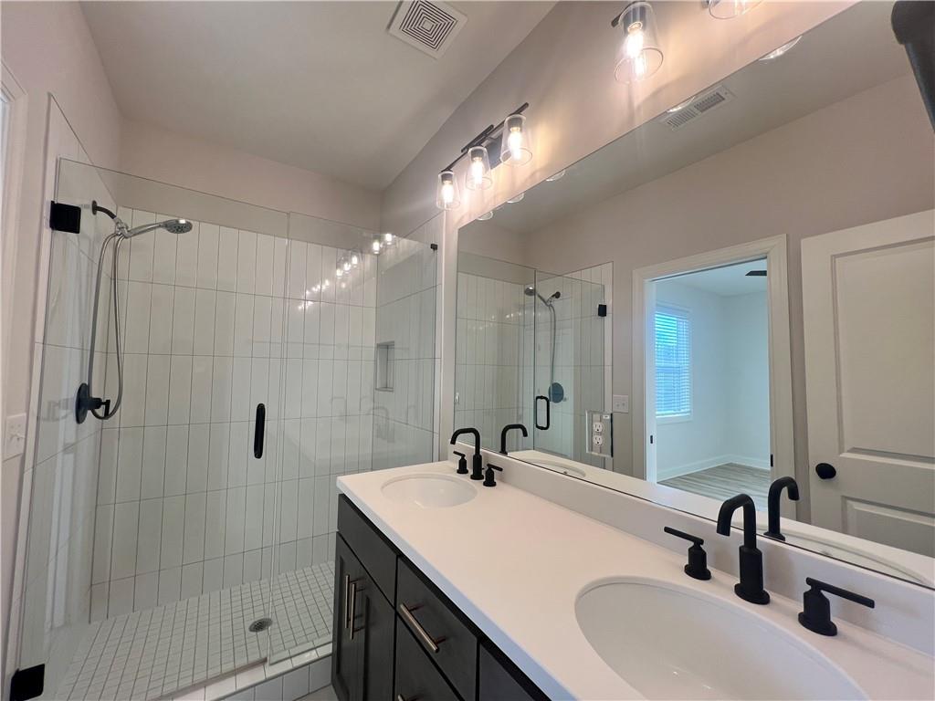 1337 Parc Bench Road Atlanta, GA 30316 - Photo 25 of 35 a bathroom with a sink double vanity and shower
