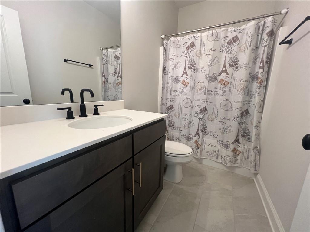 1337 Parc Bench Road Atlanta, GA 30316 - Photo 29 of 35 a bathroom with a sink a toilet and a mirror