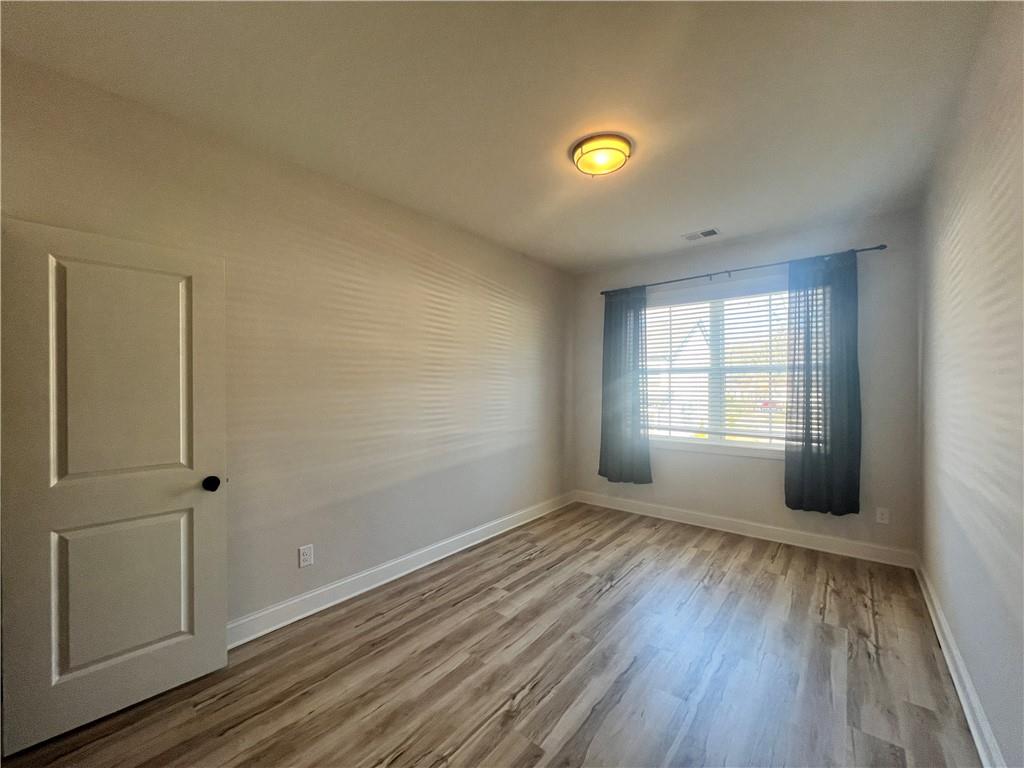 1337 Parc Bench Road Atlanta, GA 30316 - Photo 30 of 35 an empty room with wooden floor and windows