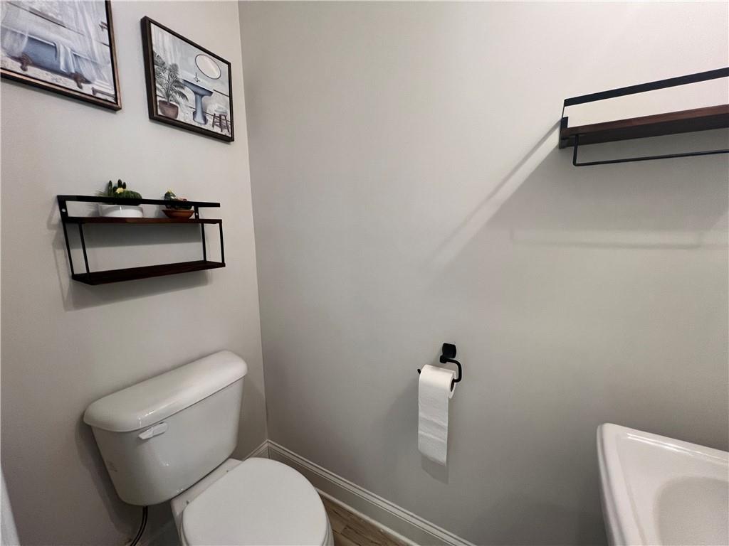 1337 Parc Bench Road Atlanta, GA 30316 - Photo 6 of 35 a white toilet sitting next to a bathroom sink