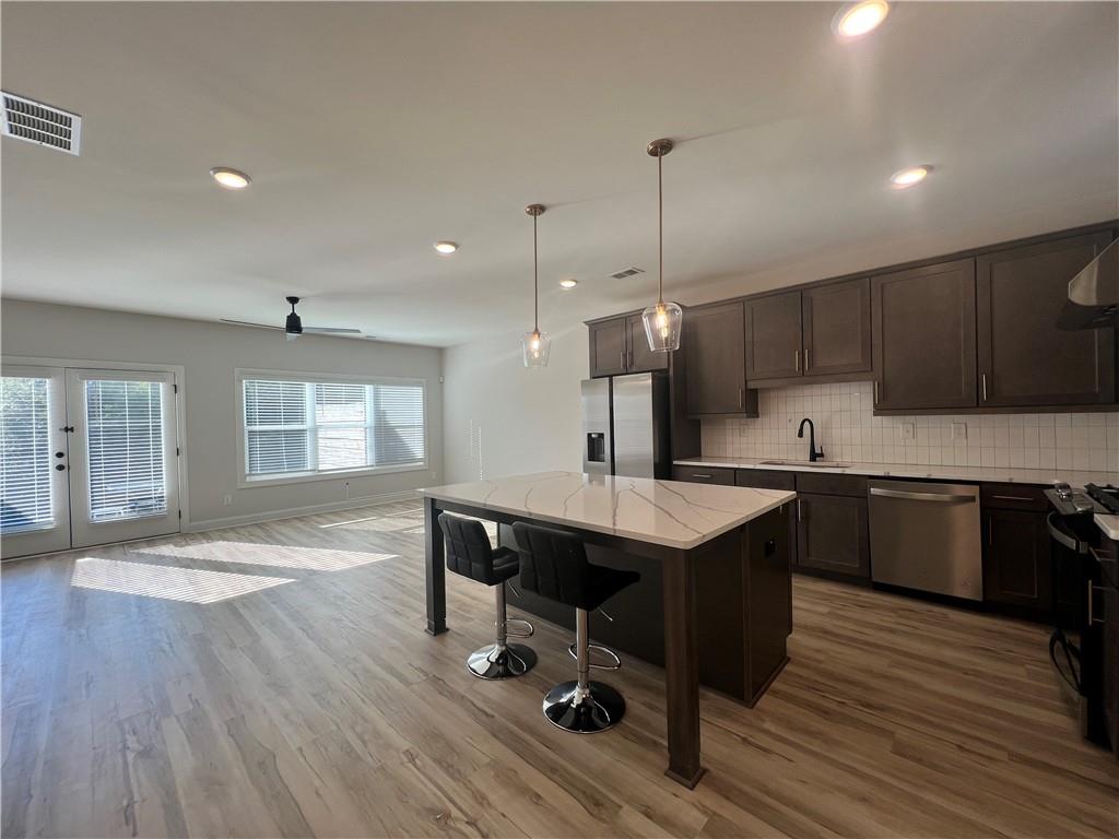 1337 Parc Bench Road Atlanta, GA 30316 - Photo 7 of 35 a kitchen with stainless steel appliances granite countertop a sink a stove a refrigerator and wooden floor