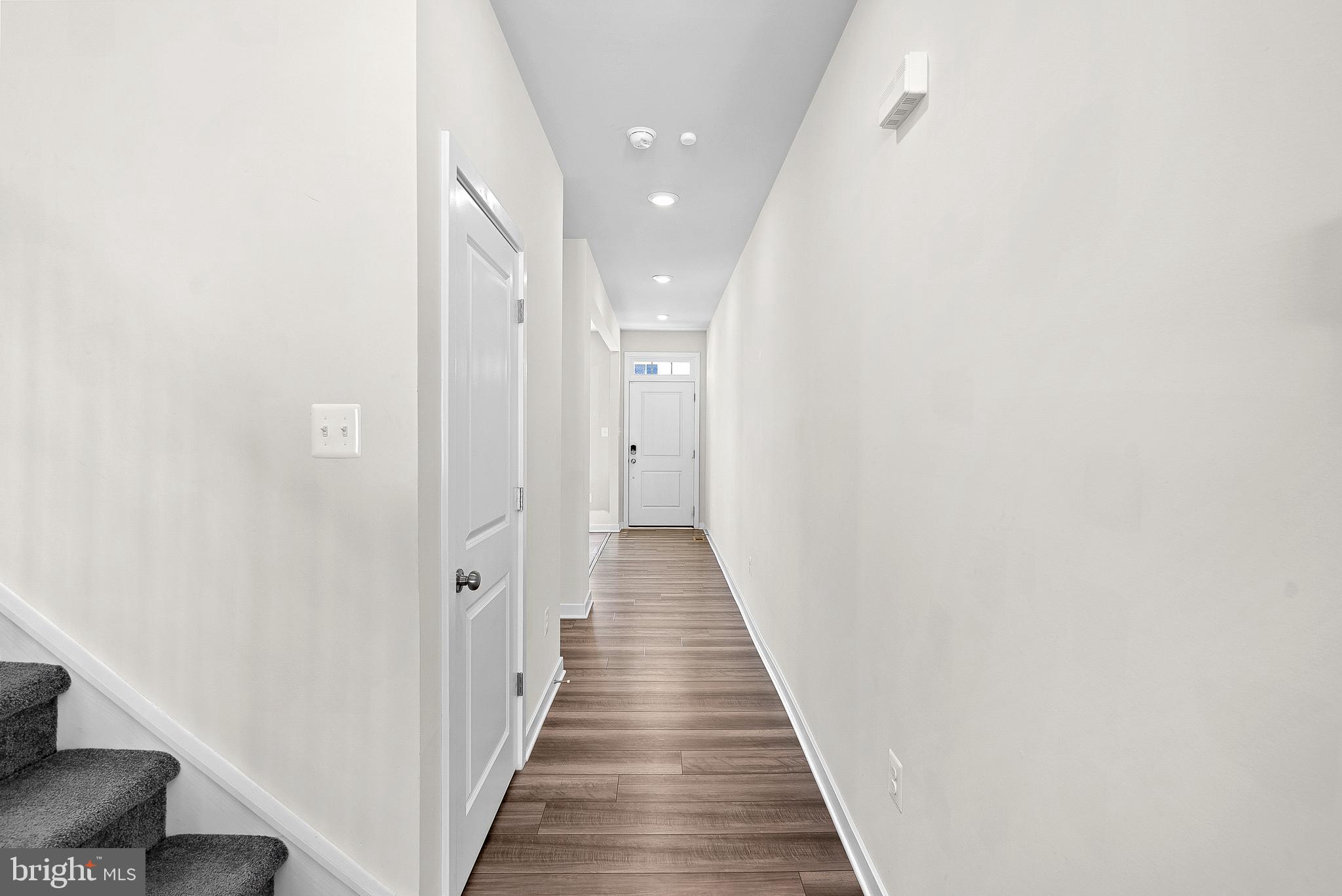 261 Short Br Drive Ranson, WV 25438 - Photo 13 of 71 a view of a hallway with wooden floor and staircase