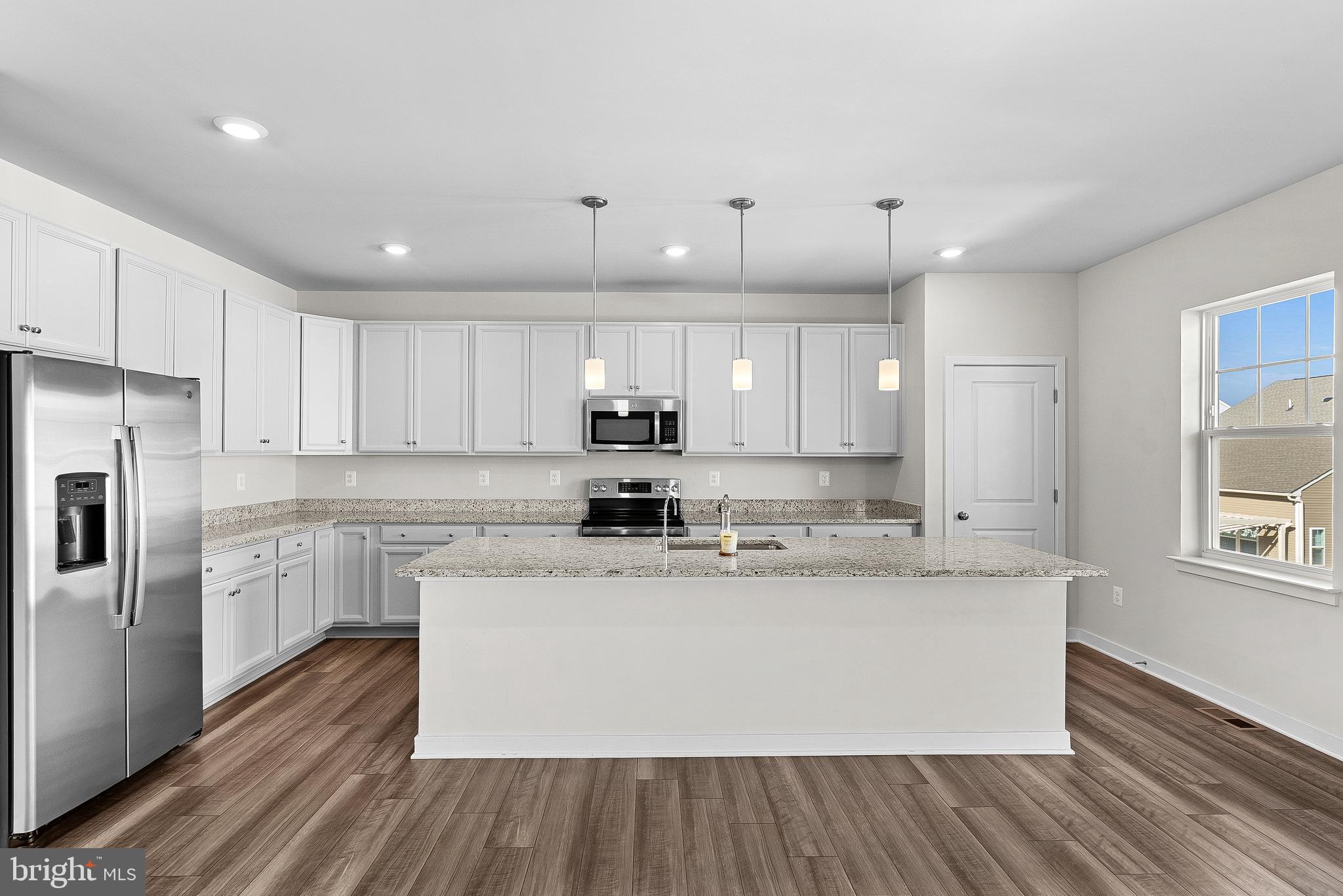 261 Short Br Drive Ranson, WV 25438 - Photo 23 of 71 a large kitchen with stainless steel appliances granite countertop a lot of counter space and wooden floors