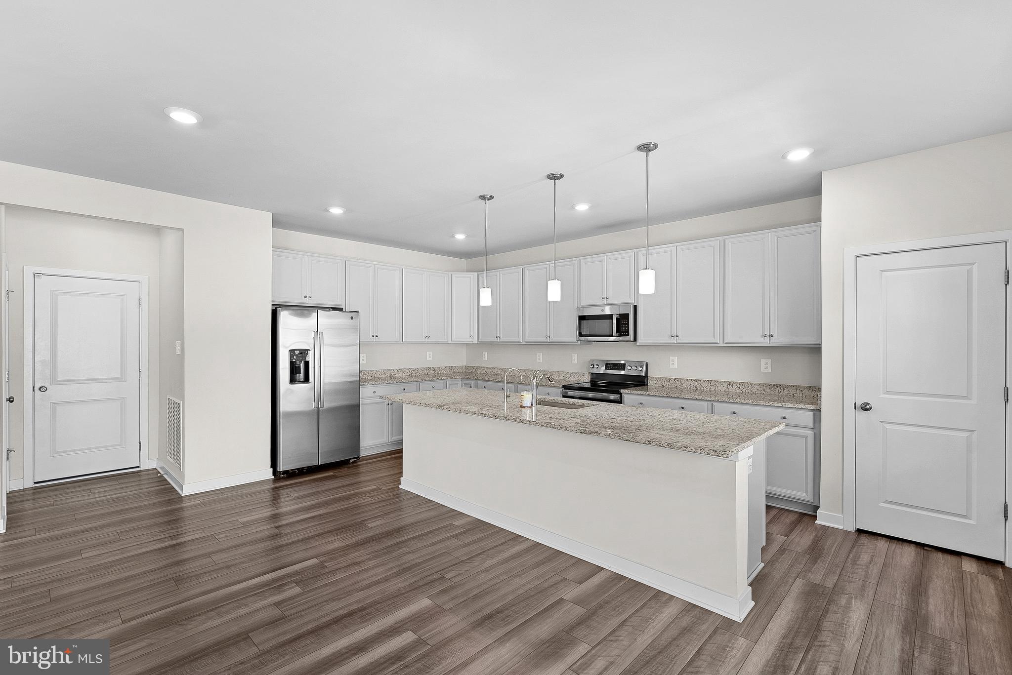 261 Short Br Drive Ranson, WV 25438 - Photo 24 of 71 a kitchen with kitchen island white cabinets and stainless steel appliances